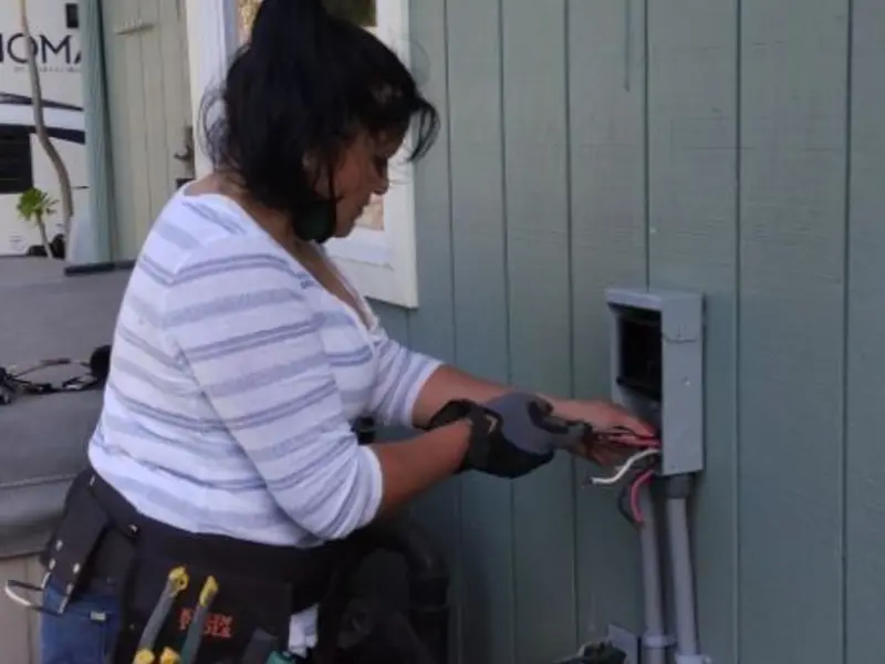 Licensed electrician wiring an exterior subpanel in Isanti